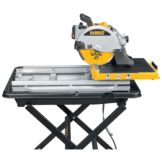 DEWALT tile saw on a black stand with yellow and silver details, used for precision cutting.