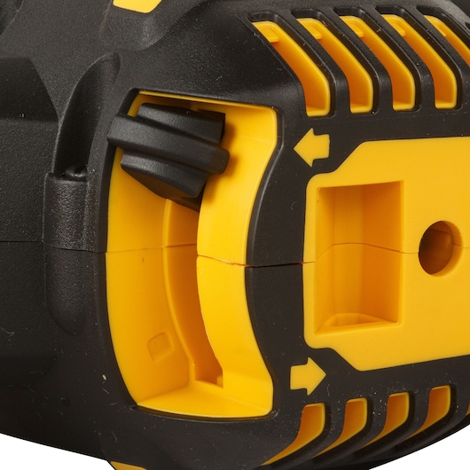 Close-up of a DEWALT tool body showing yellow and black plastic details with vent and arrow markings.