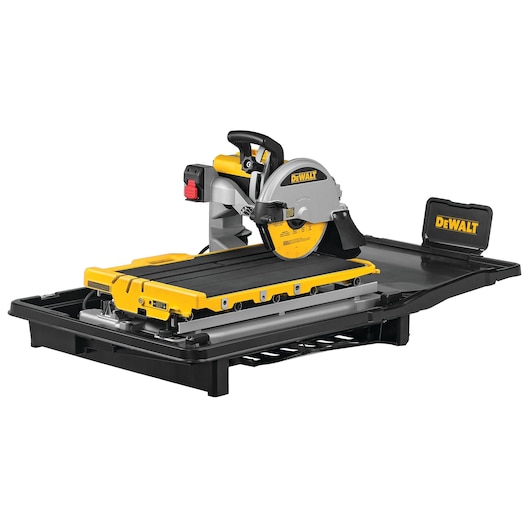 A DEWALT branded tile cutting saw with a sliding tray, featuring a yellow and black design and a water reservoir for wet cutting.