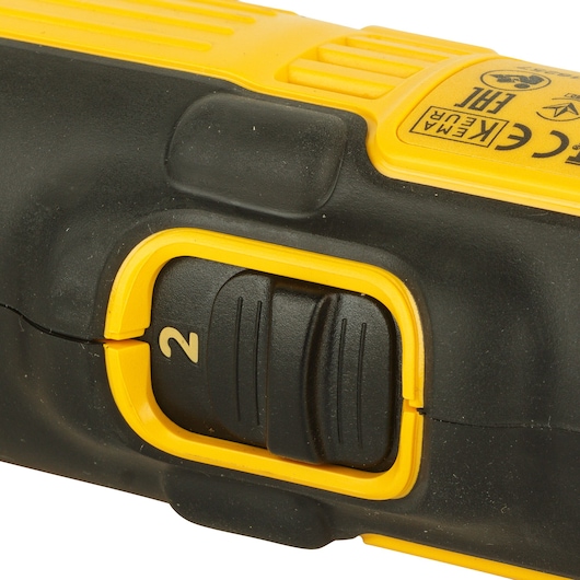 Close-up of a yellow and black DEWALT drill speed switch showing the number 2.