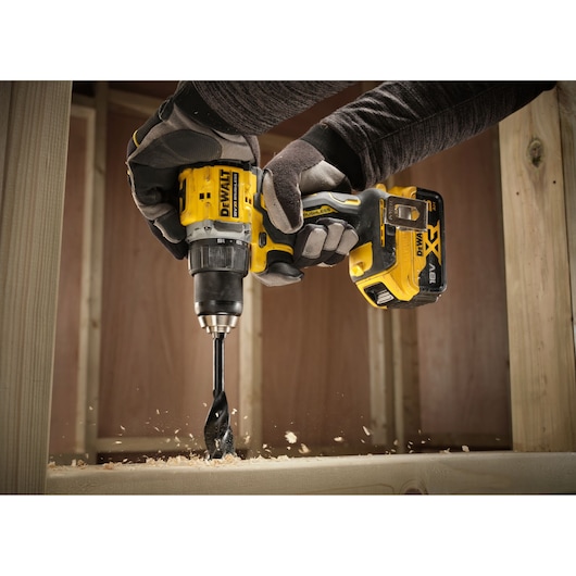 DEWALT drill DCD794P2T, DCD794P2T-QW in use drilling wood. Photography product category.