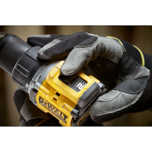 DEWALT drill close-up, model DCD794P2T and DCD794P2T-QW, being adjusted by gloved hand.