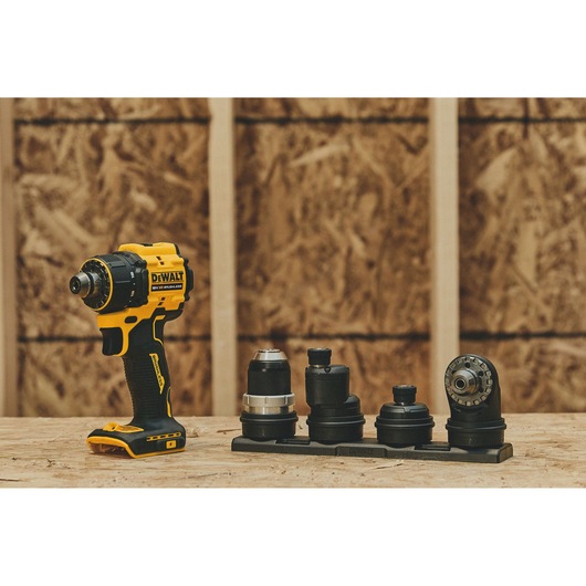 DEWALT drill DCD803NT-XJ, DCD803NT with attachments on wood in a workshop. Photography category.