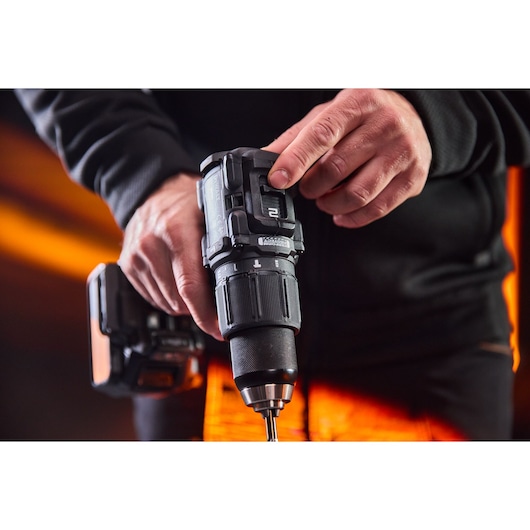 DEWALT drill DCD86MP2T-QW, DCD86MP2T held in hand. Photography category product.