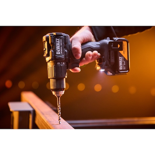 DEWALT drill in use. Photography category. SKUs: DCD86MP2T-QW, DCD86MP2T.