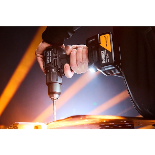 DEWALT drill used on metal. SKUs: DCD86MP2T-QW, DCD86MP2T. Photography product in action.