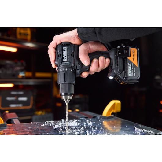 DEWALT drill in use, SKUs DCD86MP2T-QW, DCD86MP2T, drilling metal. Photography product category.