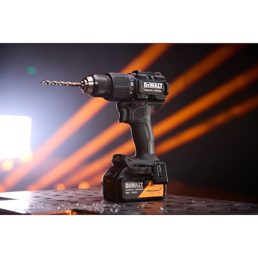 DEWALT drill for photography. Models DCD86MP2T-QW, DCD86MP2T. Shown on table with orange background lines.