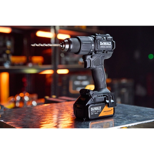 DEWALT drill DCD86MP2T-QW, DCD86MP2T with McLaren branding on a workbench. Photography category product.