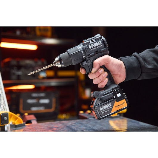 DEWALT drill, DCD86MP2T-QW and DCD86MP2T, in use. Photography product category. Battery visible.
