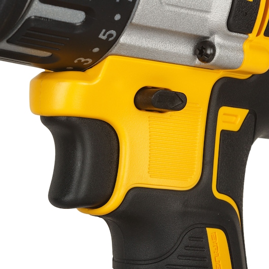 Close-up of DEWALT drill handle and switch in yellow and black, showing grip and adjustment features.