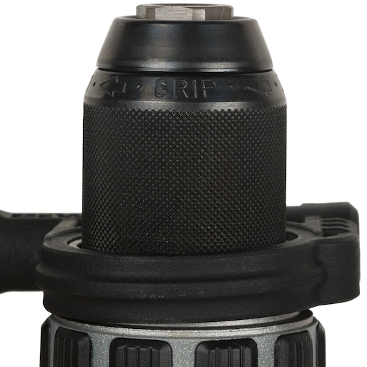 Close-up of a black textured chuck on a DEWALT power drill, showing the word GRIP and directional arrows.