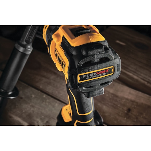 Close-up view of a DEWALT cordless drill featuring FlexVolt Advantage technology, shown on a wooden surface.