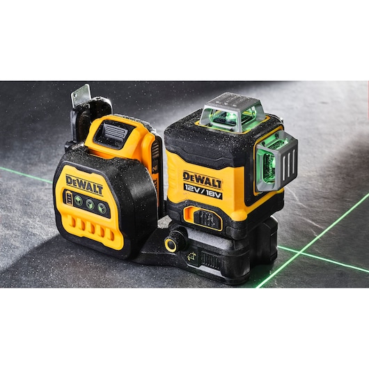 DEWALT laser level DCE089D1G18 with green lines, used for precise alignment in construction or photography.