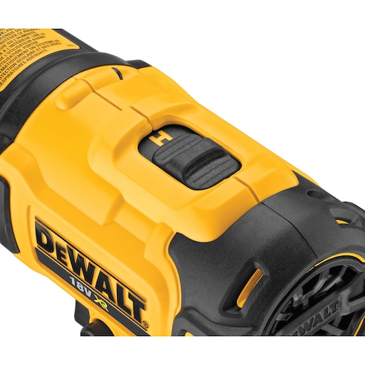 Close-up of DEWALT 18V XR tool showing yellow and black housing and control switch.