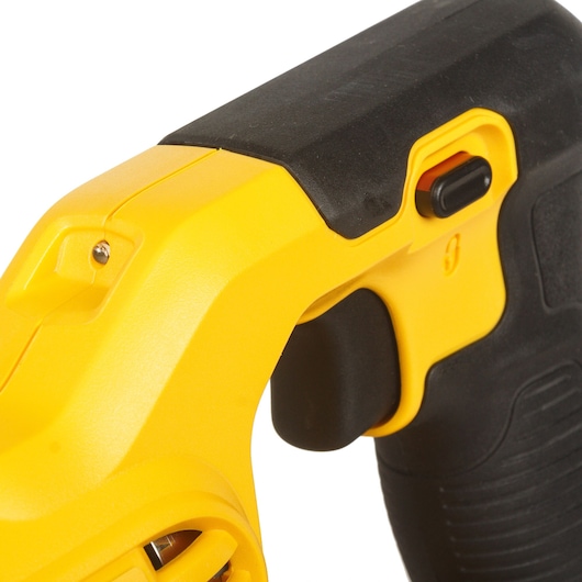Close-up of a DEWALT yellow and black power tool handle with trigger and switch detail.