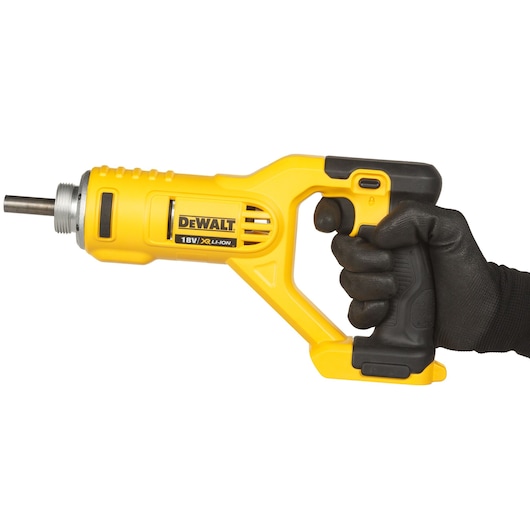 A person wearing a black glove holding a yellow DEWALT 18V power tool with a metal tip against a white background.