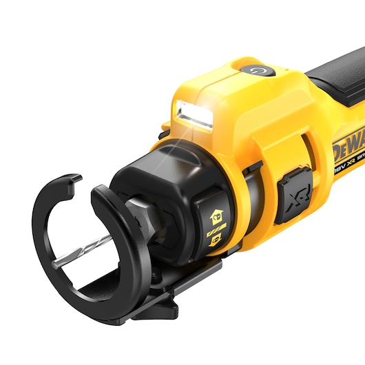 Close-up of a DEWALT rotary tool with safety guard, drill bit, and LED work light on the front.