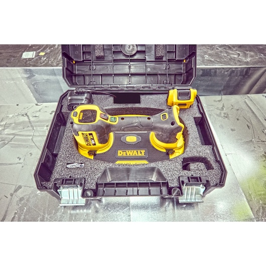 DEWALT power tool in a protective black case with foam inserts, shown with accessory and secure clasps.