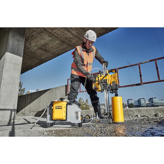 DEWALT DCE6820N, DCE6820N-XJ drilling tool in use at a construction site outdoors. Photography category.