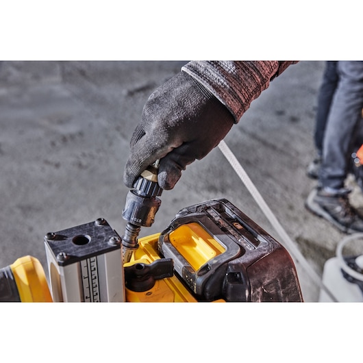 Hand adjusts DEWALT tool, model DCE6820N and DCE6820N-XJ, used for photography. Close-up view.