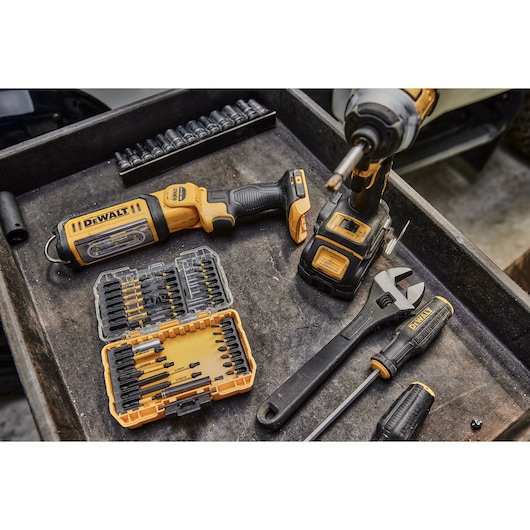 DEWALT tools including impact driver, wrench, screwdriver and a bit set are displayed in a workshop tray.