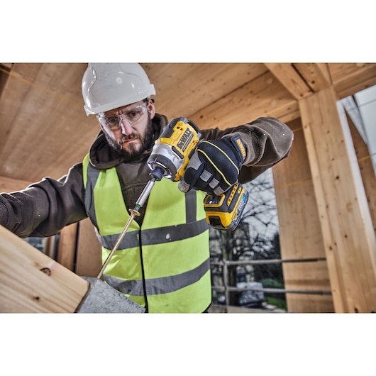 DEWALT DCK2201P1T1-XE, DCF860NT used by worker building. Photography category. Construction scene.