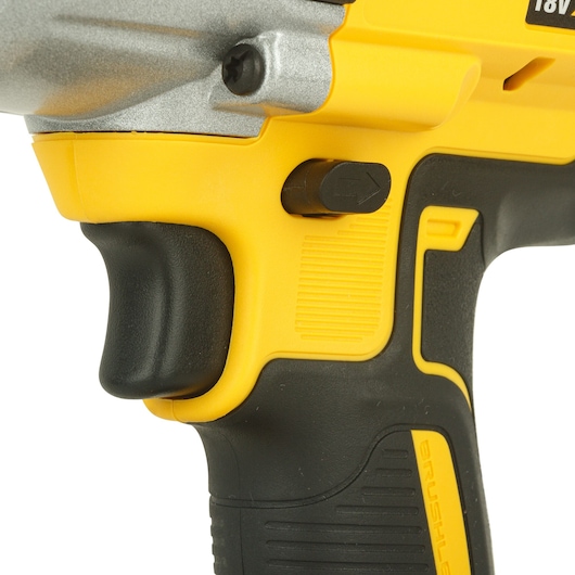 Close-up of a DEWALT DCF899NT cordless tool handle and trigger in yellow and black.