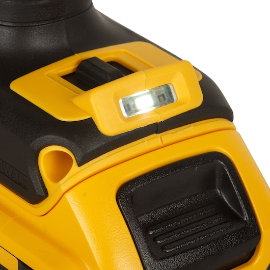 Close-up of a DEWALT power tool, showing its LED light and part of the yellow and black casing.