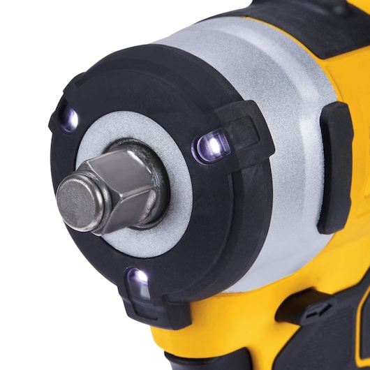 Close-up of a DEWALT cordless impact wrench head with LED lights and metallic socket connector.
