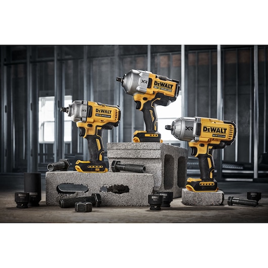 DEWALT DCF961N, DCF961N-XJ impact wrenches displayed on blocks with bolts. Photography product category.
