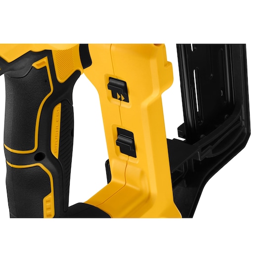 Close-up of a DEWALT tool handle with black and yellow switches and textured grip.