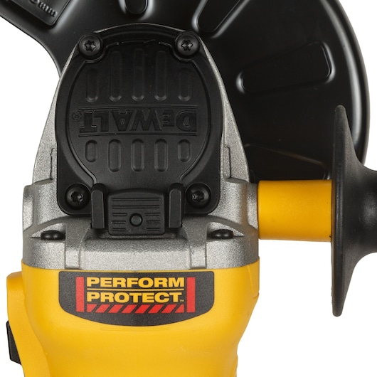 Close-up of DEWALT yellow power tool handle with Perform Protect label and part of black guard visible.