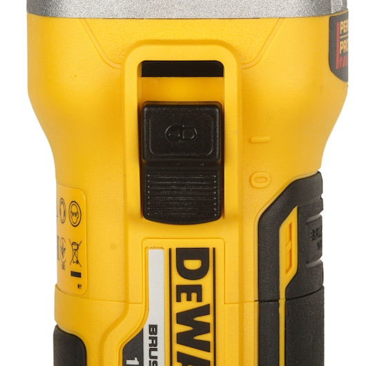 Close-up of DEWALT yellow power tool handle with switch and safety label, part of the DCG405P2-QW model.