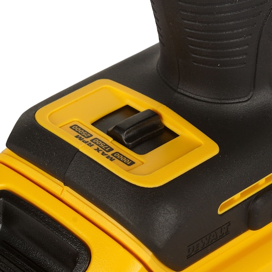 Close-up of a yellow DEWALT tool speed selector switch with max RPM settings visible.