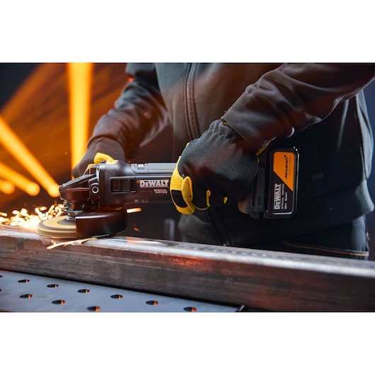 DEWALT grinder in use; sparks fly. Shown: DCG45MP2T-QW, DCG45MP2T. Photography product image.