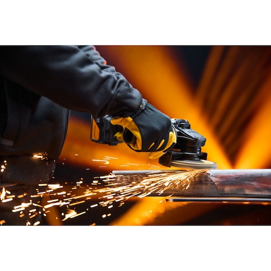 DEWALT DCG45MP2T-QW, DCG45MP2T grinder in use, sparks flying, close-up action, product category: Photography.
