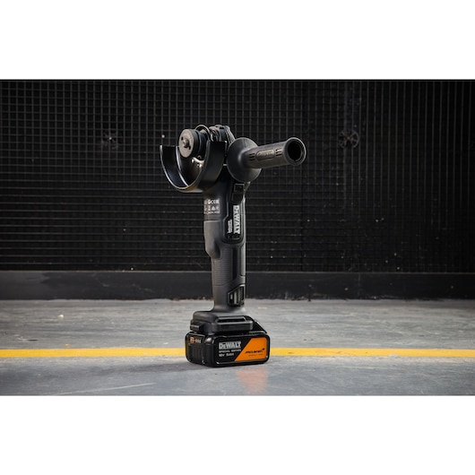 DEWALT cordless tool, DCG45MP2T-QW and DCG45MP2T SKUs, shown upright on floor against black wall.