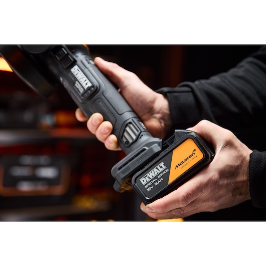 DEWALT DCG45MP2T-QW, DCG45MP2T photography tool held in hand, McLaren special edition battery visible.