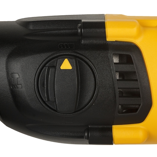 Close-up of a DEWALT tool control dial with a yellow triangle indicator and ventilation slots.