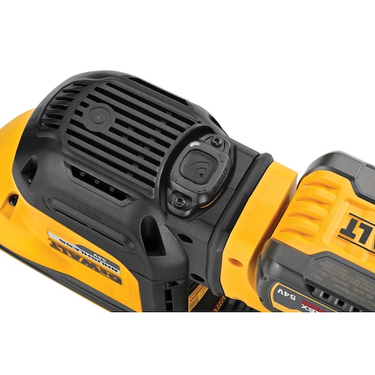 Close-up of a DEWALT power tool top, showing vent and controls in black and yellow plastic casing.