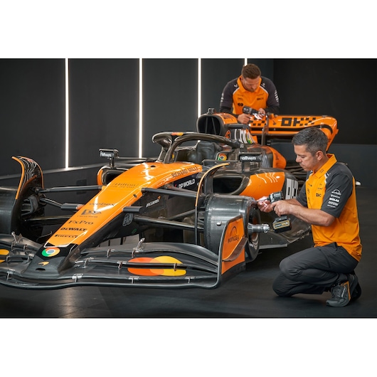 DEWALT DCK200MP2T, DCK200MP2T-XE used by engineers on an orange race car; photography product scene.