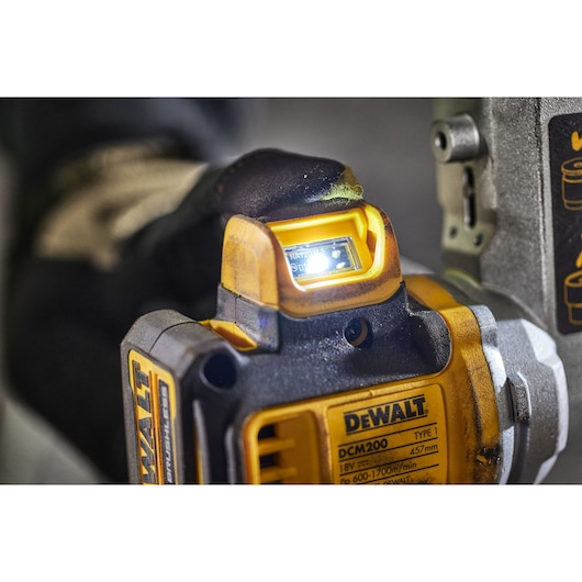 Close-up of DEWALT DCM200N power tool with illuminated display and detailed label.