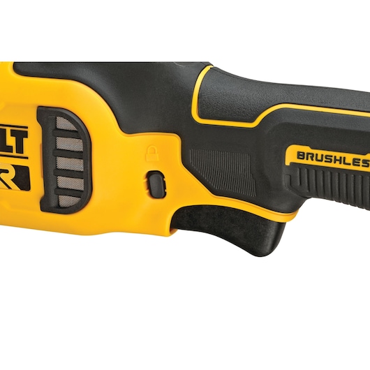 Close-up of a DEWALT brushless power tool handle, showing the yellow and black design, a safety lock switch and textured grip.