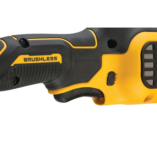Close-up of the handle and trigger area of a DEWALT power tool with a brushless motor, featuring black and yellow design elements and a textured grip.