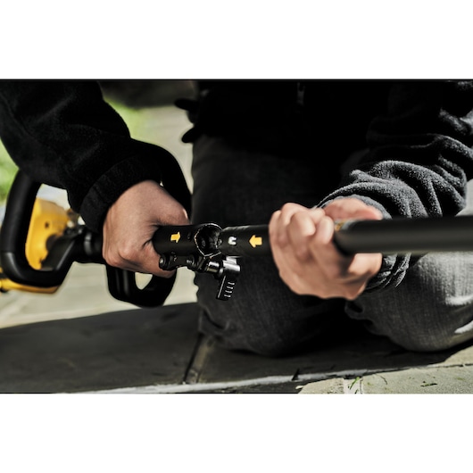Close-up of DEWALT tool adjustment, hands using DCZ65713X1-XE and DCMAS5713N. Photography product.