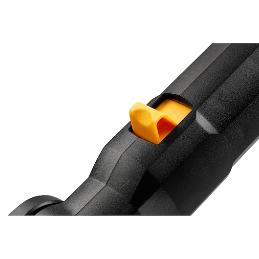 Close-up of a yellow trigger on a black DEWALT tool handle.