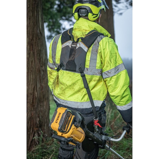 DEWALT DCMST922N, DCMST922N-XJ used outdoors by worker in high-vis jacket and helmet, product visible in use.