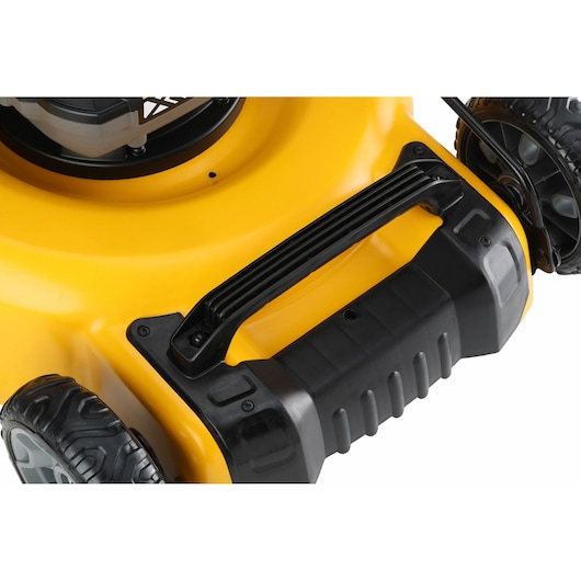 Close-up of a yellow lawn mower handle and wheels, featuring sturdy black plastic construction.