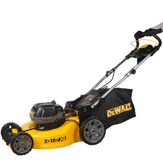 A DEWALT cordless lawn mower with a yellow and black body, featuring a grass collection bag attached to the rear. The mower is shown from a side angle on a white background.